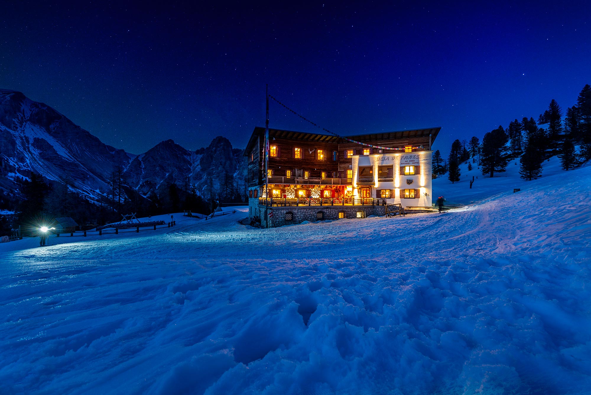 The facade of the Fanes Hut at night during the winter