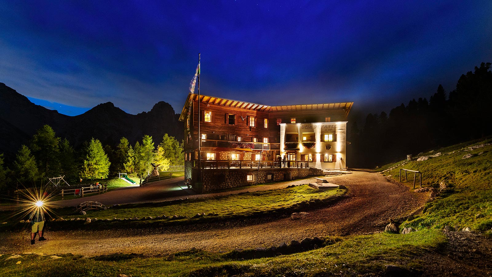 The facade of the Fanes Hut at night during the summer